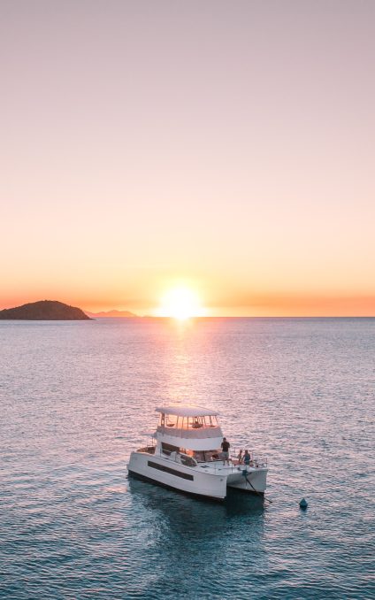 Power catamaran at sunset