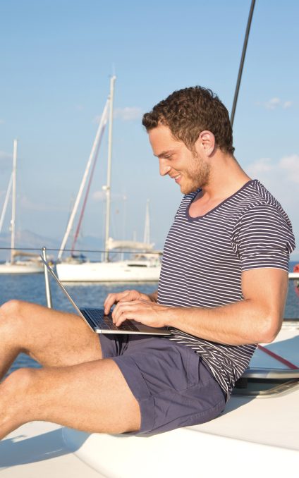 Man working on board of a yacht charter